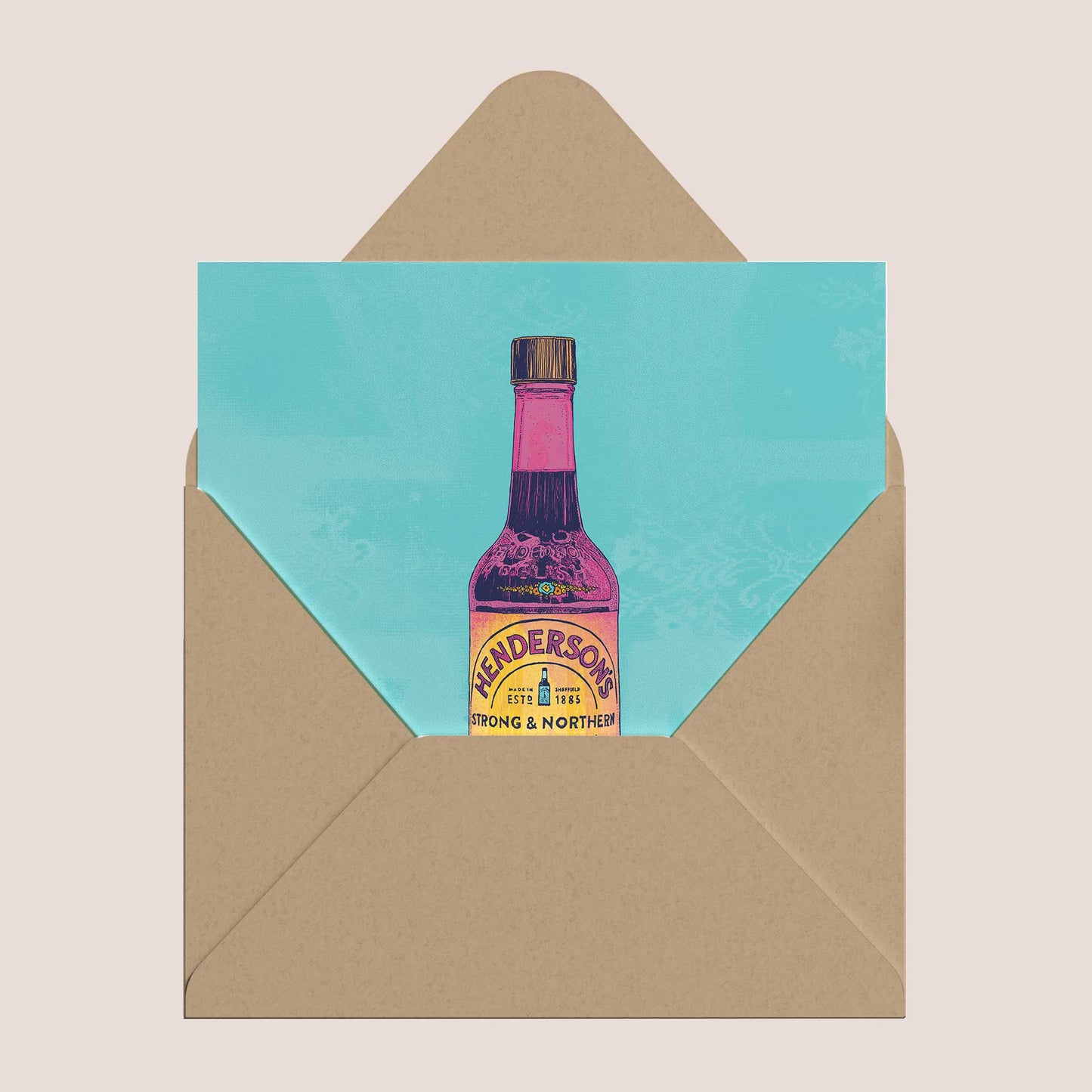 Card with Anderson's bottle design on a turquoise background, inside a brown envelope.