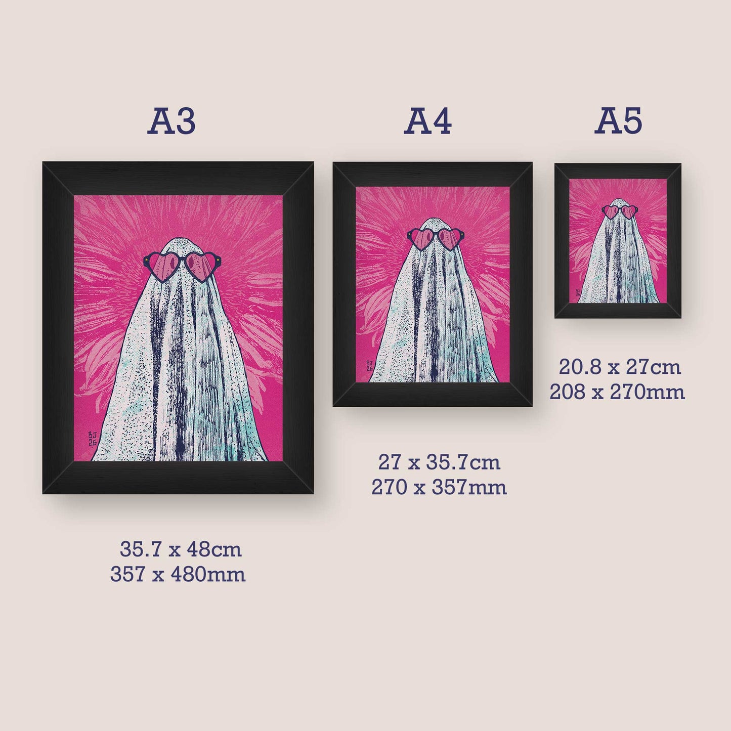 Three framed artworks of a ghost with heart sunglasses on a pink background, with size labels below.