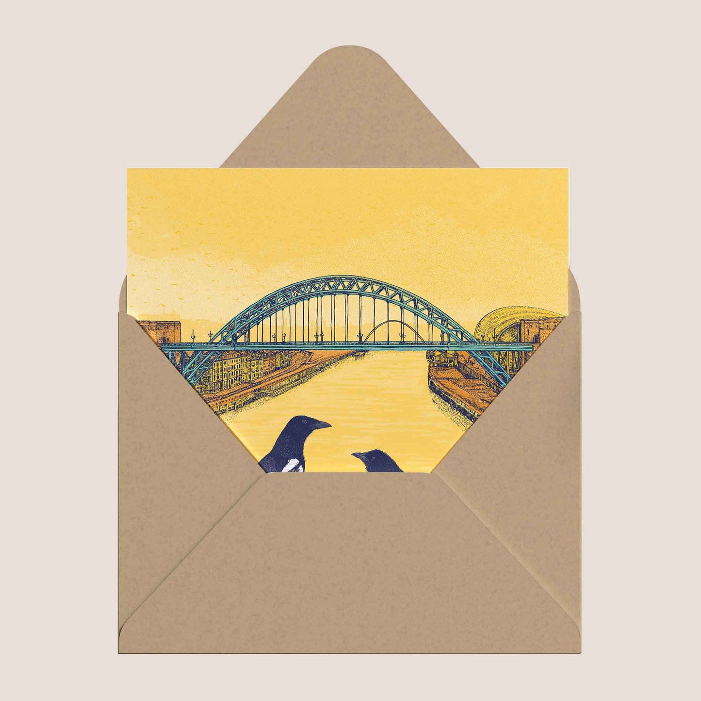 Tyne Bridge and magpies greeting card placed inside a kraft envelope.