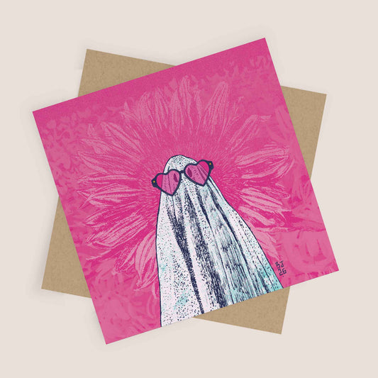 Illustrated ghost wearing heart-shaped sunglasses on a pink background