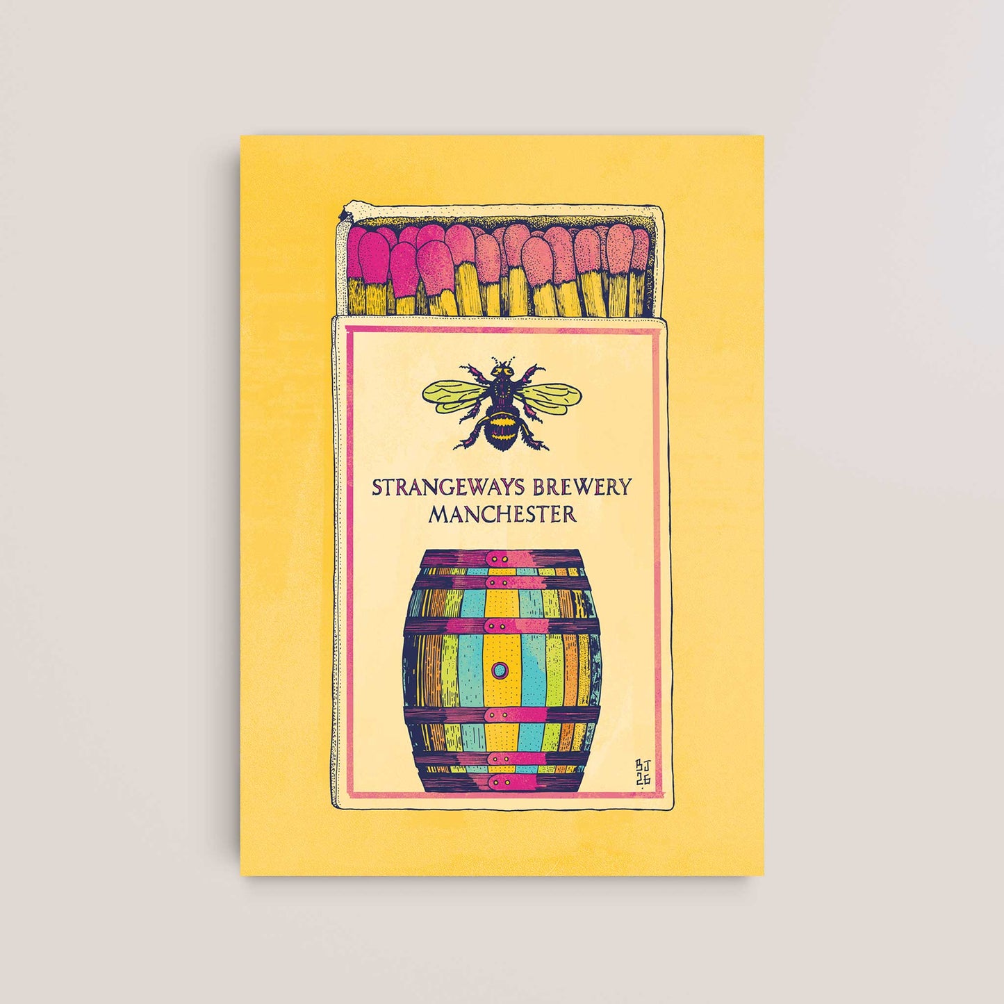 A square art print or card featuring a stylized matchbox illustration with pink matches, a bee above a colorful barrel, all on a pale yellow background. The print is photographed against a light warm gray wall.